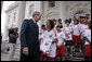President George W. Bush talks with Imane Sallah from Morocco of the World Cup Soccer Youth Delegation on the North Portico steps of the White House Monday, June 12, 2006. The delegation is comprised of 30 soccer players representing 13 countries. White House photo by Paul Morse