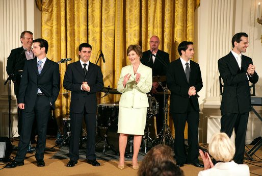Mrs. Laura Bush stands with members of the cast from the Tony award-winning musical Jersey Boys perform during a luncheon for Senate Spouses in the East Room Monday, June 12, 2006. White House photo by Shealah Craighead