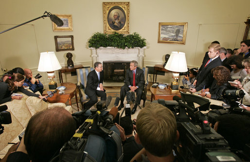 President George W. Bush and Colombian President Alvaro Uribe meet with the press in the Oval Office Wednesday, June 14, 2006. "We talked about trade. We negotiated a free trade agreement," said President Bush. "We've still got some details to work out, but we committed ourselves to working out those details and try to get this done as quickly as we can." White House photo by Paul Morse