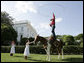 Children attending the annual Congressional Picnic on the South Lawn of the White House Wednesday evening, June 15, 2006, watch a rope trick cowboy entertainer. White House photo by Paul Morse