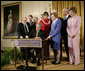 President George W. Bush signs a proclamation to create the Northwestern Hawaiian Islands Marine National Monument at a ceremony Wednesday, June 15, 2006, in the East Room of the White House. The proclamation will bring nearly 140,000 square miles of the Northwestern Hawaiian Island Coral Reef Ecosystem under the nation's highest form of marine environmental protection. Mrs. Laura Bush joined the President and distinguished guests on stage, from left to right, U.S. Rep. Neil Abercrombie, D-Hawaii; U.S. Rep. Ed Case, D-Hawaii; U.S. Sen. Daniel Akaka, D-Hawaii; U.S. Commerce Secretary Carlos Gutierrez; Hawaii Gov. Linda Lingle; documentary filmmaker Jean-Michel Cousteau; marine biologist Sylvia Earle and U.S. Interior Secretary Dirk Kempthorne. White House photo by Eric Draper