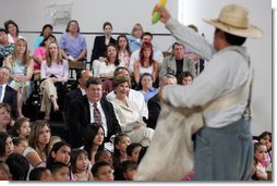 Mrs. Laura Bush watches Ricardo Araiza, one of the two actors, perform in the Childsplay production of Tomás and the Library Lady, at the Boys and Girls Club of the East Valley in Guadalupe, Arizona. The play promotes literacy and encourages young people to look past the confines of poverty, language barriers and cultural intolerance to find joy in reading.  White House photo by Shealah Craighead