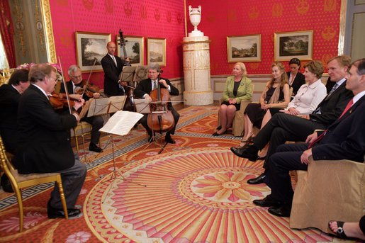 Mrs. Laura Bush listens to a concert by members of the Vienna Philharmonic at the Albertina Museum in Vienna, Austria, Wednesday, June 21, 2006, where she was also given a tour of the museum. White House photo by Shealah Craighead