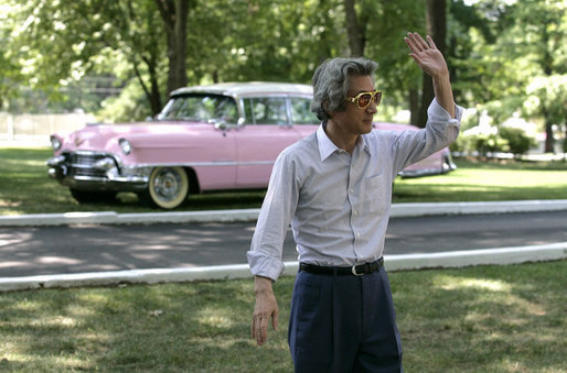 Japan's Prime Minister Junichiro Koizumi stands before a classic pink Cadillac and waves to reporters as he wears a pair of Elvis Presley style sunglasses during his tour Friday, June 30, 2006 of Presley's mansion, Graceland, with President George W. Bush and Mrs. Laura Bush in Memphis. White House photo by Eric Draper