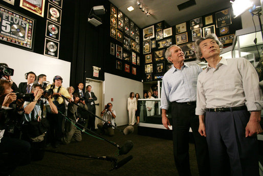President George W. Bush and Japanese Prime Minister Junichiro Koizumi gaze at the awards that decorate the Racquetball Room during a tour of Graceland, the home of Elvis Presley, given by his former wife Priscilla Presley and their daughter Lisa-Marie Presley, Friday, June 30, 2006, in Memphis. White House photo by Shealah Craighead