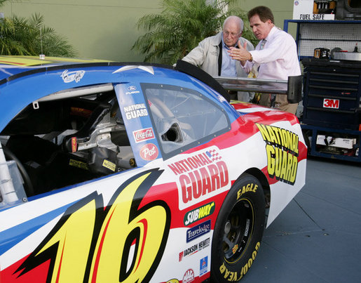 Vice President Dick Cheney is shown the National Guard NASCAR racing car by former NASCAR driver and Winston Cup champion Darrell Waltrip Saturday, July 1, 2006, prior to the start of the 2006 Pepsi 400 race at Daytona International Speedway in Daytona, Fla. White House photo by David Bohrer