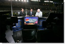 Vice President Dick Cheney talks with Chris Myers, left, and Jeff Hammond, center, of Fox Sports Network, Saturday, July 1, 2006, during a live TV interview held during the 2006 Pepsi 400 NASCAR race at Daytona International Speedway in Daytona, Fla.  White House photo by David Bohrer