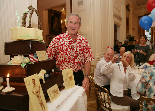 President George W. Bush is presented with a birthday cake Tuesday evening, July 4, 2006, during a dinner party at the White House. President Bush will celebrate his 60th birthday on Thursday. White House photo by Shealah Craighead