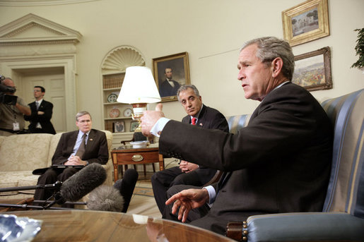 President George W. Bush and Zalmay Khalilzad, U.S. Ambassador to Iraq, meet with the press in the Oval Office Thursday, July 6, 2006. White House photo by Eric Draper
