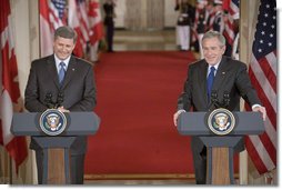 President George W. Bush and Canadian Prime Minister Stephen Harper hold a joint press conference in the East Room Thursday, July 6, 2006. "The President and I have agreed to task our officials to provide a more forward-looking approach focused on the environment, climate change, air quality and energy issues in which our governments can cooperate," said Prime Minister Harper. "We raised the issue of how regulatory cooperation could increase productivity, while helping to protect our health, safety, and environment." White House photo by Kimberlee Hewitt