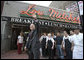 President George W. Bush waves as he leaves Lou Mitchells Restaurant in Chicago, Friday, July 7, 2006, following a breakfast meeting with local business leaders at the restaurant.  White House photo by Kimberlee Hewitt