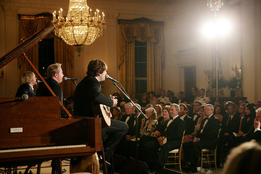 President George W. Bush, Mrs. Laura Bush and guests listen to the band Rascal Flatts in the East Room of the White House following a dinner honoring the Special Olympics and founder Eunice Kennedy Shriver, Monday, July 10, 2006. White House photo by Shealah Craighead