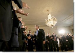 President George W. Bush greets the audience after delivering remarks on the economy and budget, Tuesday, July 11, 2006, in the East Room at the White House. White House photo by Eric Draper