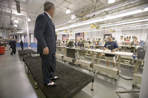 President George W. Bush shows off his new red, white and blue shoes that were presented to him during his visit to the Allen-Edmonds Shoe Corporation in Port Washington, Wis., Tuesday, July 11, 2006. "I'm thrilled with my new shoes," said the President to the press. "I wish I had them on the Fourth of July." White House photo by Kimberlee Hewitt