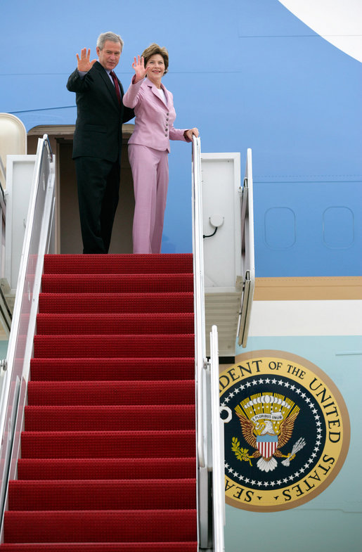 President George W. Bush and Laura Bush wave from Air Force One at Andrews Air Force Base en route to Germany and Russia Wednesday, July 12, 2006. President Bush will meet with Chancellor Angela Merkel in Germany and attend the G8 Summit in St. Petersburg, Russia. White House photo by Eric Draper