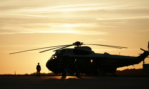 A military guard stands post next to Marine One on the tarmac at Rostock-Laage Airport Wednesday, July 12, 2006, awaiting the arrival of President George W. Bush and Mrs. Laura Bush. The couple was scheduled to visit with German Chancellor Angela Merkel before proceeding to the G8 Summit in Russia. White House photo by Paul Morse