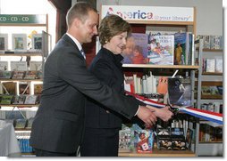 Mrs. Laura Bush participates in a ribbon cutting, assisted by Michael Gawenda, director of the City Library of Stralsund, Thursday, July 13, 2006, at the Stralsund Children’s Library in Stralsund, Germany, to open the exhibit America@yourlibrary. The America@yourlibrary is a new initiative to develop existing and new partnerships between German public libraries and the U.S. Embassy and Consulate Resource Centers. White House photo by Shealah Craighead