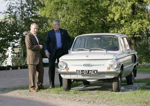President George W. Bush and Russian President Vladimir Putin look over the first car owned by President Putin, a Zaporozhets, Friday, July 14, 2006, before they attend a social dinner at the Konstantinovsky Palace in Strelna, Russia. White House photo by Eric Draper