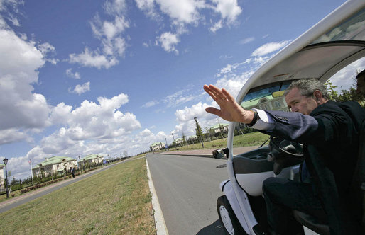 President George W. Bush drives his electric GEM car to a meeting during the G8 Summit at Konstantinvosky Palace Complex in Strelna, Russia, July 16, 2006. Each of the G8 leaders is provided with a car that is decorated with the flag of the leader's nation. White House photo by Eric Draper