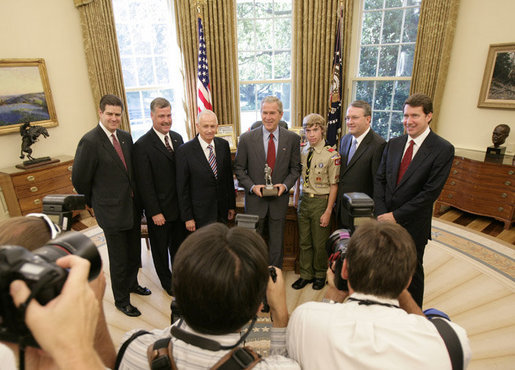 President George W. Bush poses for photos in the Oval Office of the White House Tuesday, July 18, 2006, with members of the National Capital Area Council of the Boy Scouts of America, from left to right, Jim Turley, Al Lambert, Bill Marriott Jr., CJ McWilliams, Jack Gerard and Bill Hagerty. White House photo by Eric Draper
