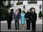 President George W. Bush and Laura Bush welcome outgoing Archbishop of Washington Theodore Cardinal McCarrick, left, the incoming Archbishop of Washington Donald W. Wuerl, right, and Papal Nuncio Pietro Sambi to the White House Tuesday evening, July 18, 2006, for a dinner in their honor. White House photo by Kimberlee Hewitt