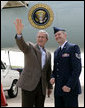 President George W. Bush meets with U.S. Air Force Tech. Sgt. Brian Webster next to Air Force One Friday, July 21, 2006, where he honored Webster with the President’s Volunteer Service Award at Buckley Air Force Base in Aurora, Colo. Tech. Sgt. Webster is co-founder and treasurer of the Hearts Across the Miles, a non-profit organization to providedeployed military personnel with care packages and thank you letters. White House photo by Eric Draper