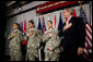 President George W. Bush recites the Pledge of Allegiance Monday, July 24, 2006, at Walter Reed Army Medical Center in Washington, D.C., joining newly sworn-in American citizens, Specialist Sergio Lopez, 24, of Bowlingbrook, Ill., left, Specialist Noe Santos-Dilone of Brooklyn, N.Y., center, and Private First Class Eduardo Leal-Cardenas of Los Angeles, Calif., during their naturalization ceremony.  White House photo by Eric Draper