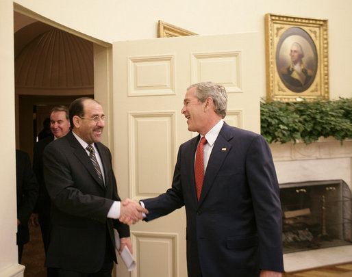 President George W. Bush welcomes Iraqi Prime Minister Nouri al-Maliki into the Oval Office of the White House Tuesday, July 25, 2006, where the two leaders talked about plans to expand the security presence in the neighborhoods of the Iraqi capital. White House photo by Eric Draper