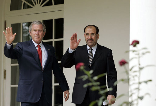 President George W. Bush and Iraqi Prime Minister Nouri al-Maliki walk along the colonnade of the Rose Garden after meeting in the Oval Office Tuesday, July 25, 2006. White House photo by Paul Morse