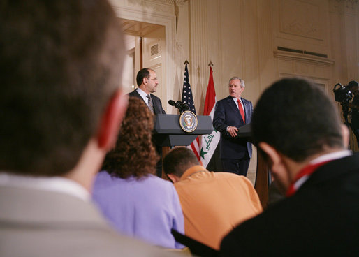 President George W. Bush and Iraqi Prime Minister Nouri al-Maliki take questions from reporters at a joint press availability in the East Room of the White House Tuesday, July 25, 2006, where they answered questions on security in Iraq and the ongoing crisis in Lebanon. White House photo by David Bohrer