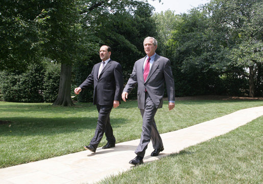 President George W. Bush and Iraqi Prime Minister Nouri al-Maliki walk from the Oval Office toward the South Lawn of the White House Wednesday, July 26, 2006, to board Marine One for their trip to Fort Belvoir, Va., to meet military personnel and families. White House photo by David Bohrer