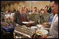 President George W. Bush speaks with military personnel as he makes his way along a buffet line during a visit to Fort Belvoir, Va., Wednesday, July 26, 2006. White House photo by Paul Morse