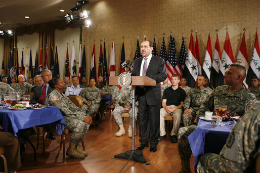 President George W. Bush listens as Iraqi Prime Minister Nouri al-Maliki speaks to military personnel and their families during his visit to Fort Belvoir, Va., Wednesday, July 26, 2006. White House photo by Paul Morse