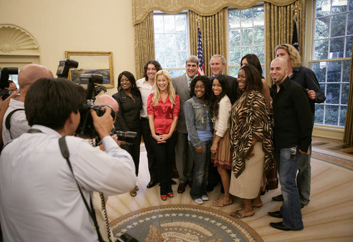 President George W. Bush welcomes nine of the top 10 American Idol finalists to the Oval Office at the White House Friday, July 28, 2006. The popular FOX television program, which originated in 2002, uses audience participation to determine the best “undiscovered” young singer in the nation. Top row from left to right are Jamecia Bennett, mother of performer Paris Bennett, Ace Young, American Idol winner Taylor Hicks, Katherine McPhee, Bucky Covington, bottom row from left to right, Kellie Pickler, Paris Bennett, Lisa Tucker, Mandisa Hundley and Chris Daughtry. White House photo by Eric Draper