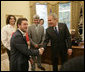 President George W. Bush welcomes Elliot Yamin, one of the top 10 American Idol finalists who arrived late to the Oval Office at the White House Friday, July 28, 2006, along with Yamin’s fellow performers, from left to right, Ace Young, Kelli Pickler, American Idol winner Taylor Hicks and Katharine McPhee. The popular FOX television program, which originated in 2002, uses audience participation to determine the best “undiscovered” young singer in the nation. White House photo by Eric Draper