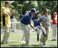 A player for the Shady Spring Little League Challenger Braves of Shady Spring W. Va., is helped around the bases Sunday, July 30, 2006, at the White House Tee Ball on the South Lawn game against the Thurmont Little League Civitan Club of Frederick Challengers of Thurmont, Md. White House photo by Paul Morse