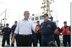 President George W. Bush stands with Admiral Thad Allen, Commandant of the U.S. Coast Guard, as he talks with reporters following his tour of the U.S. Coast Guard Integrated Support Command at the Port of Miami Monday, July 31, 2006.  White House photo by Kimberlee Hewitt