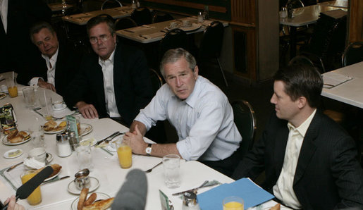 President George W. Bush meets business leaders and his brother, Florida Governor Jeb Bush, left, in Miami at the Versailles Restaurant and Bakery for a breakfast meeting Monday, July 31, 2006. White House photo by Kimberlee Hewitt