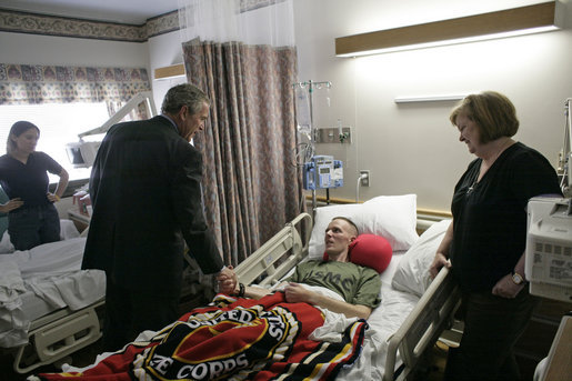 President George W. Bush visits U.S. Marine Corps. Maj. James Browning of Natchez, Miss., and his mother, Brenda, at the National Naval Medical Center in Bethesda, Md., Tuesday, Aug. 1, 2006. White House photo by Eric Draper