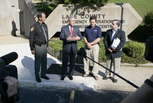 President George W. Bush is joined by Lake County Sheriff Dan Dunlap, left; Larry Greene, director of the Lake County Emergency Management Agency and Jesse Munoz of the Federal Emergency Management Agency, right, as President Bush spoke to reporters Wednesday, Aug. 2, 2006 outside the Lake County Emergency Management Agency facility in Mentor, Ohio, following a meeting on the Lake County flood response following severe storms that caused major flooding in numerous counties in July. White House photo by Kimberlee Hewitt
