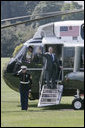 President George W. Bush waves from the steps of Marine One on the South Lawn of the White House Thursday, Aug. 3, 2006, as he departs to visit the U.S.-Mexico border patrol facilities in McAllen and Mission, Texas. White House photo by Kimberlee Hewitt