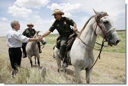 President George W. Bush meets with mounted U.S. Border Patrol agents along the U.S.-Mexico border Thursday, Aug. 3, 2006, in the Rio Grande Valley border patrol sector in Mission, Texas. White House photo by Eric Draper