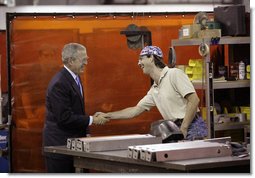 President George W. Bush speaks with a metal worker Thursday, Aug. 10, 2006, during his tour and visit with employees at Fox Valley Metal-Tech in Green Bay, Wis. White House photo by Eric Draper