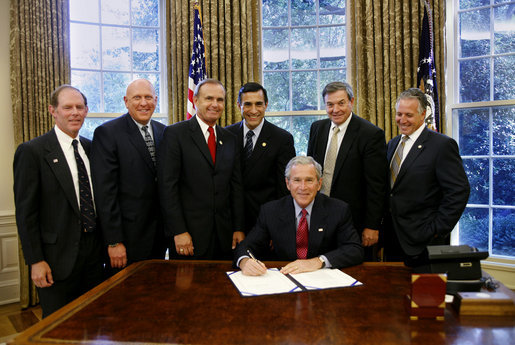 President George W. Bush prepares to sign H.R. 5683, to preserve the Mt. Soledad Veterans Memorial in San Diego, Calif., Monday, Aug. 14, 2006, at a signing ceremony in the Oval Office of the White House, which will provide for the immediate acquisition of the memorial by the United States. Joining President Bush at the signing, from left to right, Bill Kellogg, president of the Mount Soledad Association; Philip Thalheimer, chairman, San Diegans for Mt. Soledad National War Memorial; U.S. Rep. Brian Bilbray, R-Calif.; U.S. Rep. Darrell Issa, R-Calif.; U.S. Rep. Duncan Hunter, R- Calif.; and Chuck LiMandri, chief counsel, San Diegans for Mt. Soledad National War Memorial. White House photo by Paul Morse