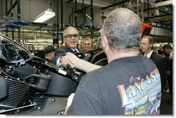 President George W. Bush meets workers along the assembly line during a tour of the Harley-Davidson Vehicle Operations facility Wednesday, Aug. 16, 2006 in York, Pa., where he participated in a roundtable discussion on the economy.  White House photo by Kimberlee Hewitt