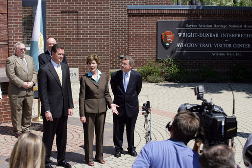 Mrs. Laura Bush joined by, from left, U.S. Rep. Mike Turner and U.S. Sen. Mike DeWine talk to the press after touring Wright-Dunbar Village in Dayton, Ohio, Wednesday, August 16, 2006. The Village is a Preserve America neighborhood that is home to the historic sites where the Wright brothers worked on the inventions that led to flight and Paul Laurence Dunbar printed his newspaper. White House photo by Shealah Craighead