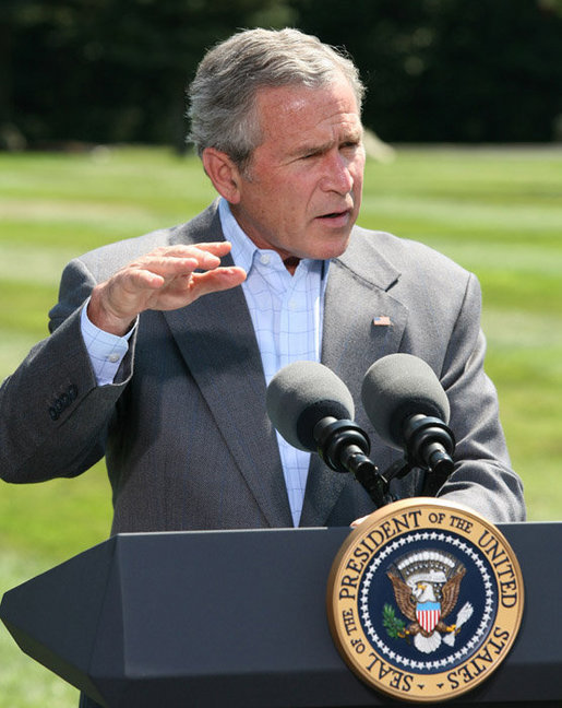 President George W. Bush gestures as he answers a reporter's question Friday, Aug. 18, 2006 in Camp David, Md., following a meeting with his economic advisors. White House photo by Eric Draper
