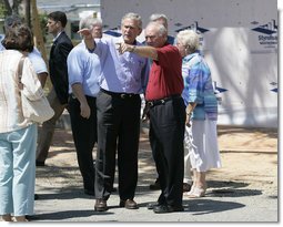 President George W. Bush is joined by Biloxi, Miss. Mayor A.J. Holloway, right, Monday, Aug. 28, 2006, during President Bush’s walking tour in the same Biloxi neighborhood he visited following Hurricane Katrina in September 2005. The tour allowed President Bush the opportunity to assess the progress of the area’s recovery and rebuilding efforts following the devastating hurricane. White House photo by Eric Draper