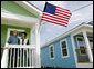 President George W. Bush stands with Fredy Omar outside his newly built home Tuesday, Aug. 29, 2006, in the Musicians' Village, where the President and Mrs. Bush hosted an outdoor luncheon for approximately 50 Habitat for Humanity volunteers in appreciation of their work at the 9th Ward home site. White House photo by Eric Draper