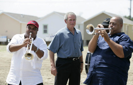 President George W. Bush is greeted by the New Birth Brass Band as he arrives Tuesday, Aug. 29, 2006, at the Habitat for Humanity's Musician's Village in New Orleans' 9th Ward, where he had lunch with volunteers and local residents. The Village will consist of 81 Habitat-constructed homes for displaced New Orleans musicians. White House photo by Eric Draper